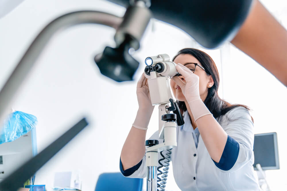 Low angle view of gynecologist examines patient