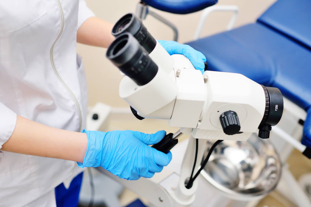 a young female gynecologist is preparing to examine