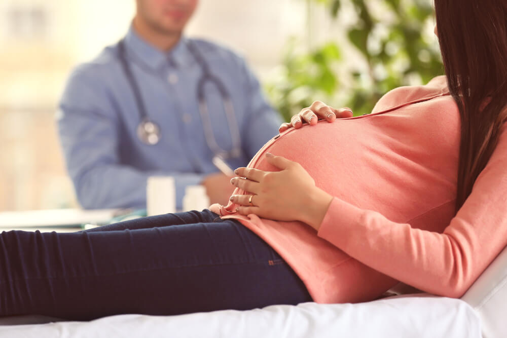 Pregnant woman with doctor at hospital