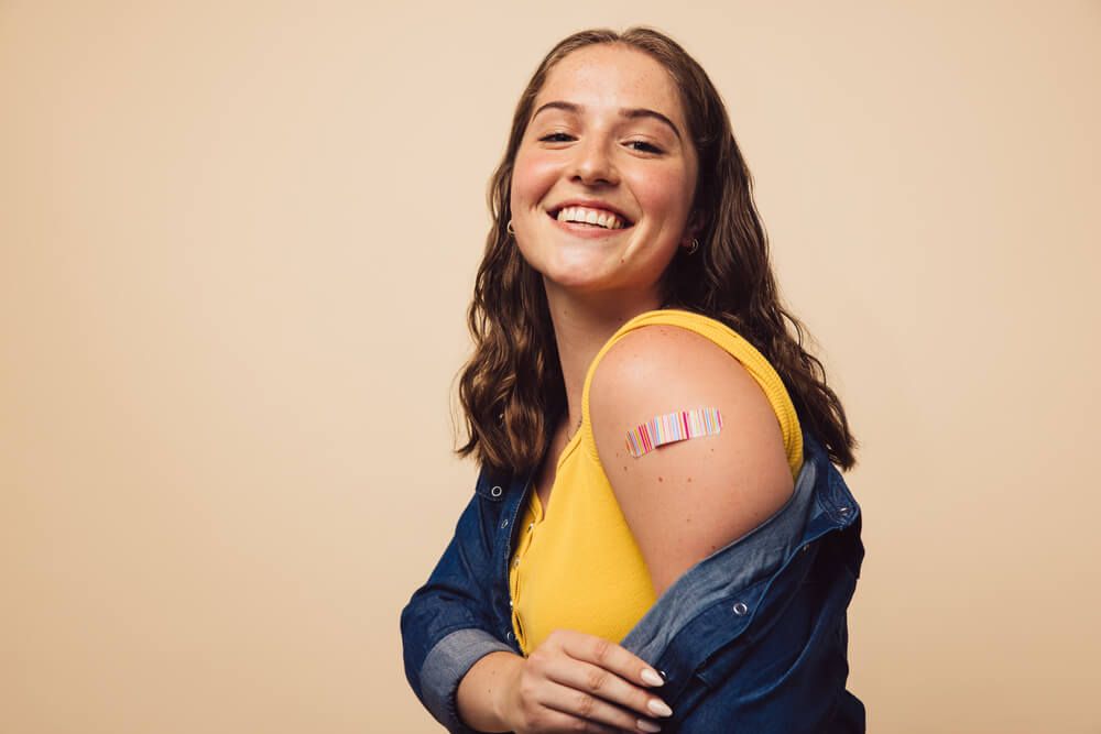 Portrait of a female smiling after getting a vaccine.