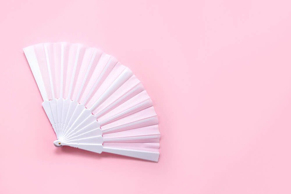 White fan on pink background
