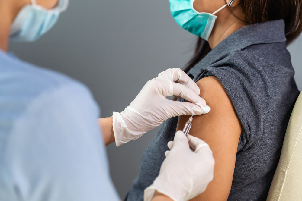 Doctor holding syringe and using cotton before make injection