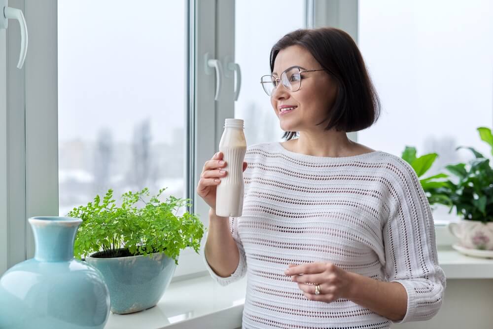 Middle-aged woman drinking milk