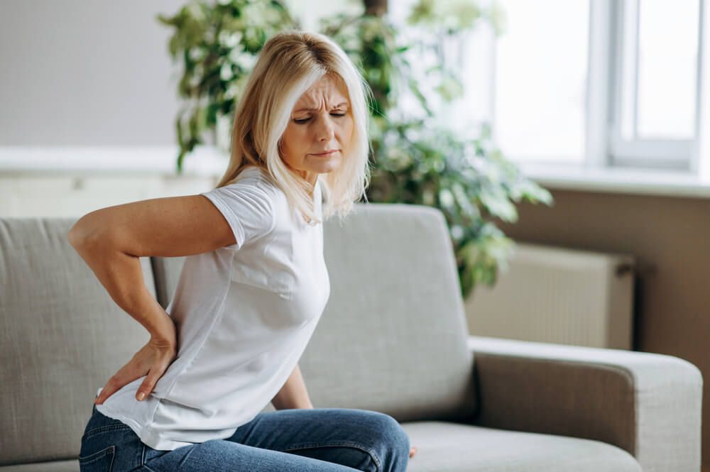Upset mature woman suffering from backache