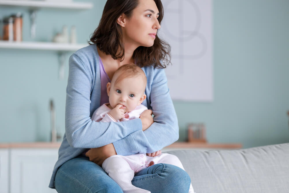 Young woman suffering from postnatal depression