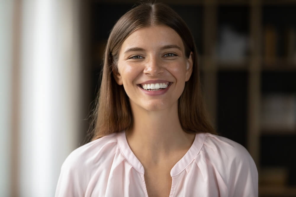 Happy beautiful young woman with perfect white teeth