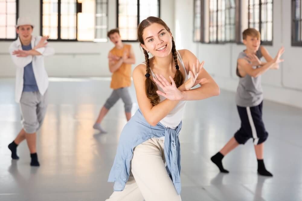 Emotional teenage girl having group dance training