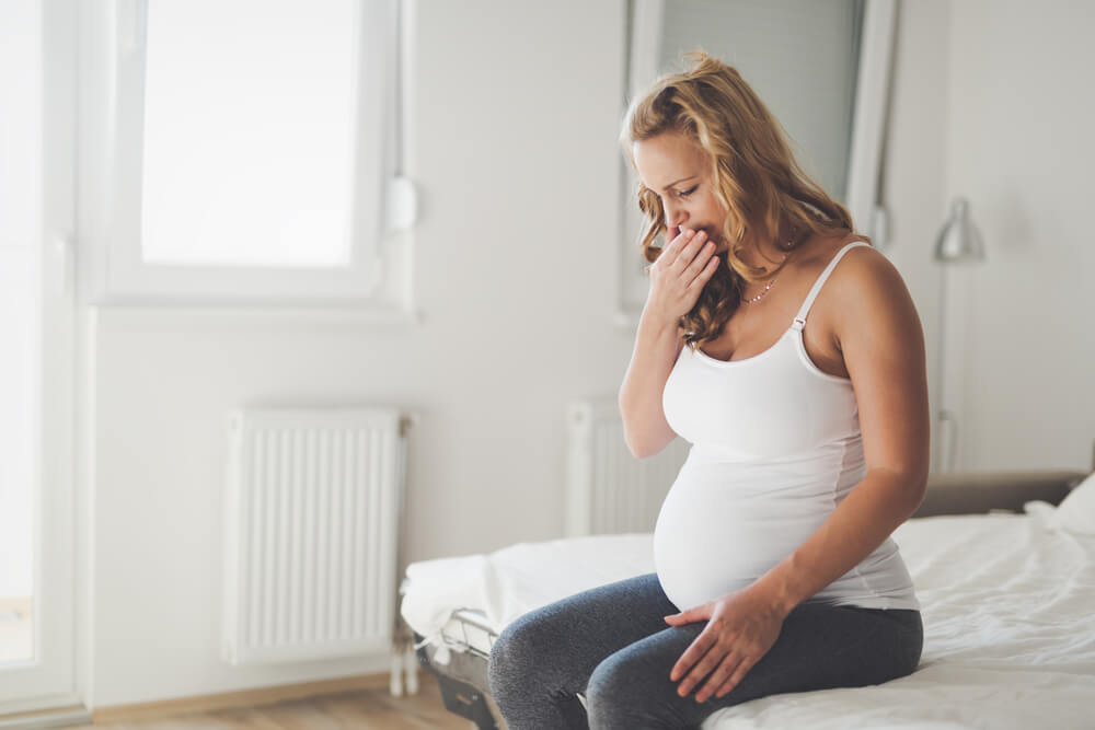 Pregnant woman suffering with nausea in morning