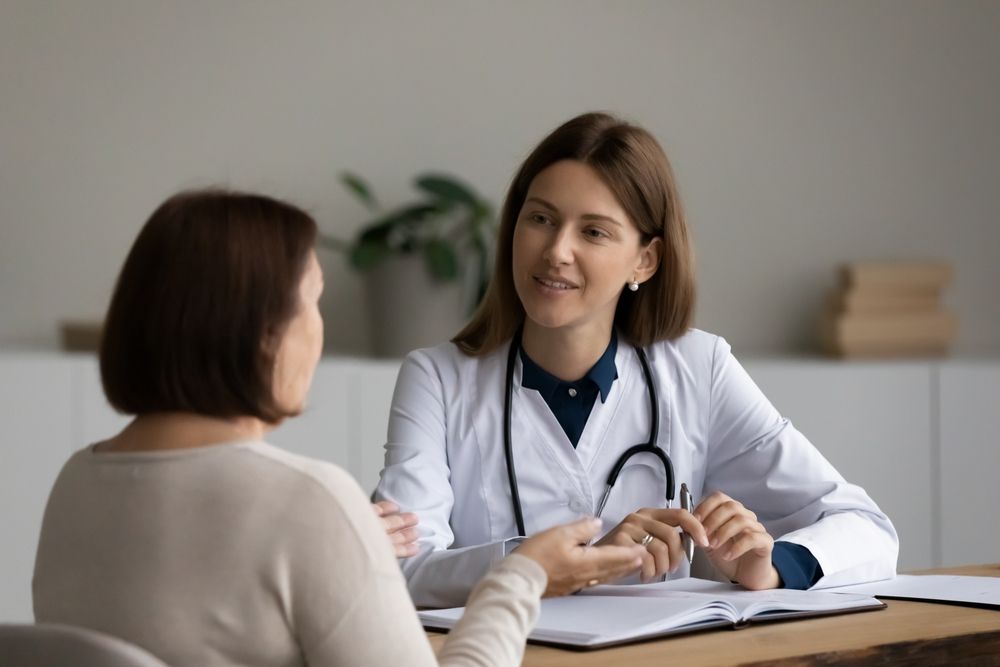 Doctor speaking with a patient about Heavy Menstrual Bleeding