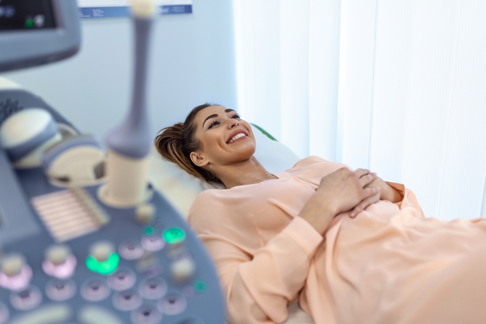 Happy pregnant female visiting women's doctor in the maternity center