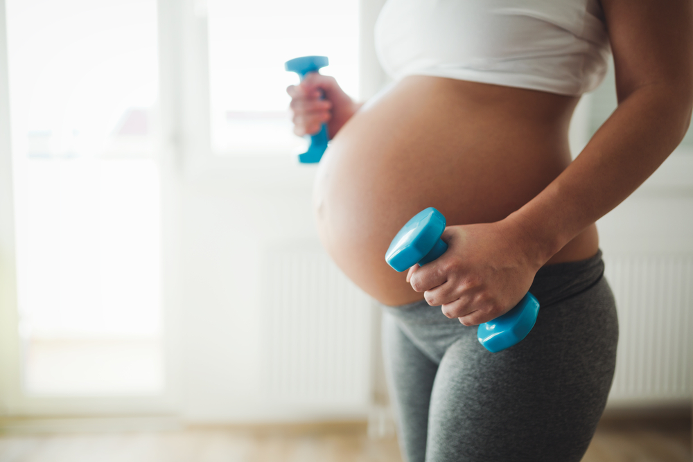 Pregnant woman practicing fitness and working out during pregnancy