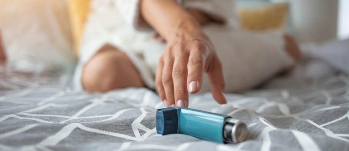 Asmathic girl catching inhaler having an asthma