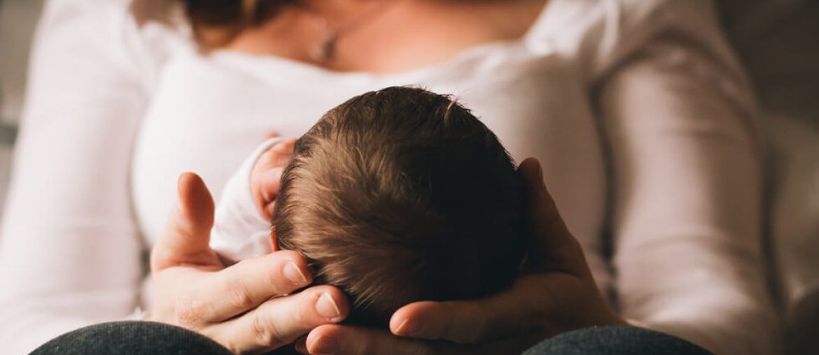 New mom holding newborn baby in her arms