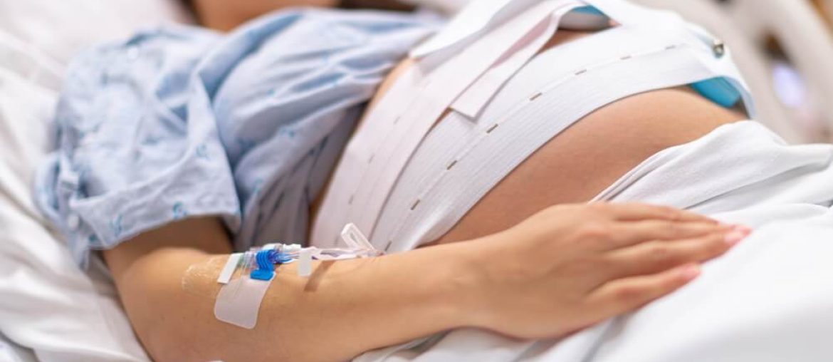 A pregnant woman in the hospital delivery room