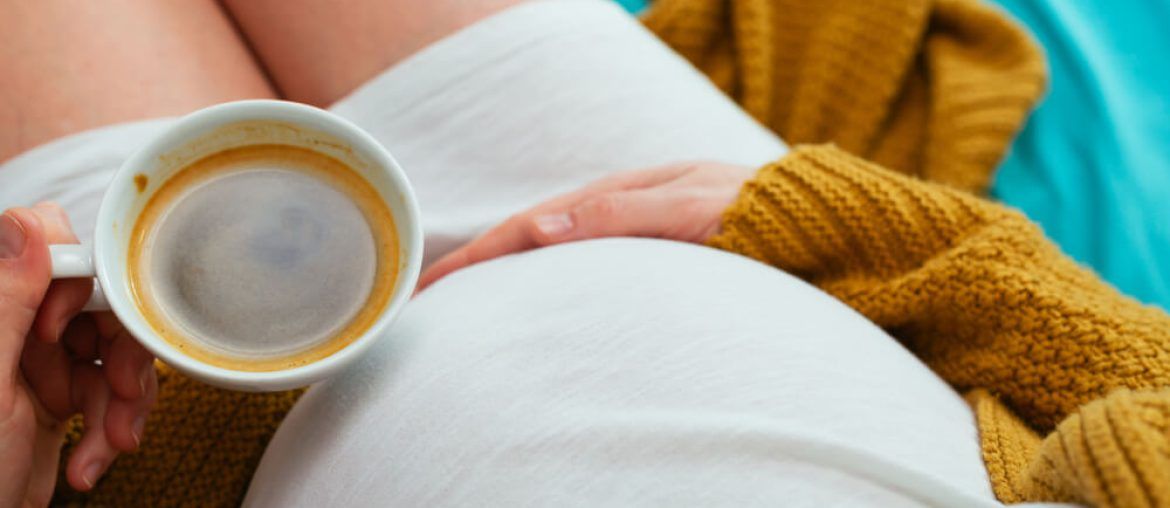 Pregnant woman drinking coffee