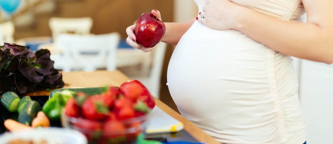 Pregnant woman healthy eating vegetables and fruit