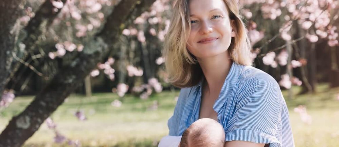 Beautiful mother breastfeeding baby