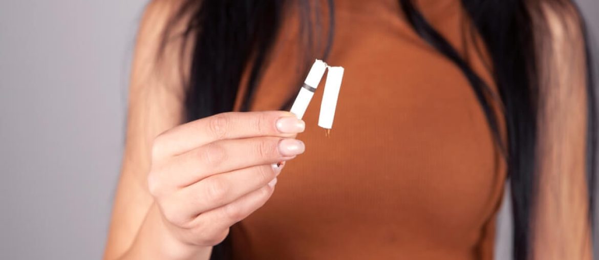 women holding a cigarette in their hands.