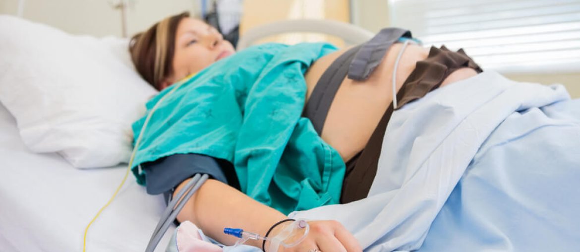 Birthing woman in hospital with IV in arm