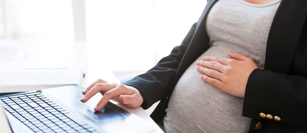 Pregnant woman working on laptop