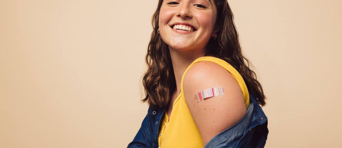 Portrait of a female smiling after getting a vaccine.