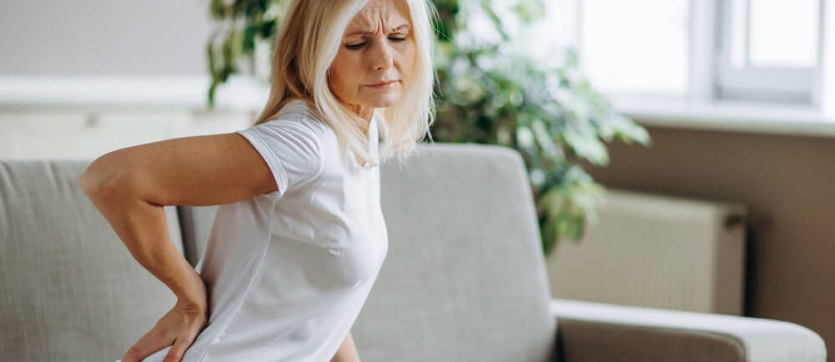 Upset mature woman suffering from backache