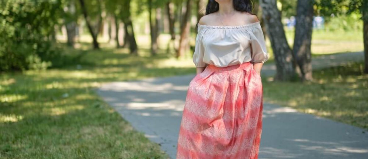 Middle-aged attractive woman with dark hair, enjoying nature in the forest