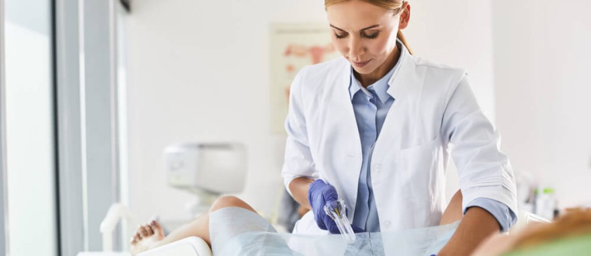 Waist up portrait of gynecologist in white lab coat