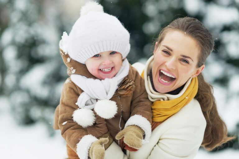 Happy Mother And Baby In Winter Park