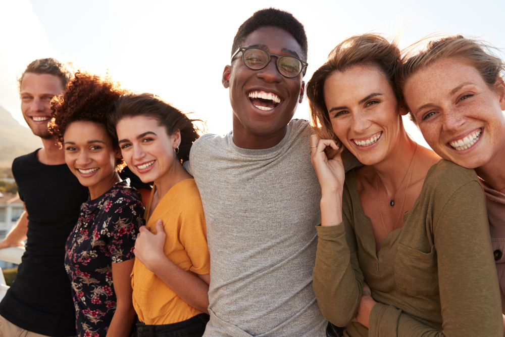 Smiling,Young,Friends,Walking,Outdoors,Together