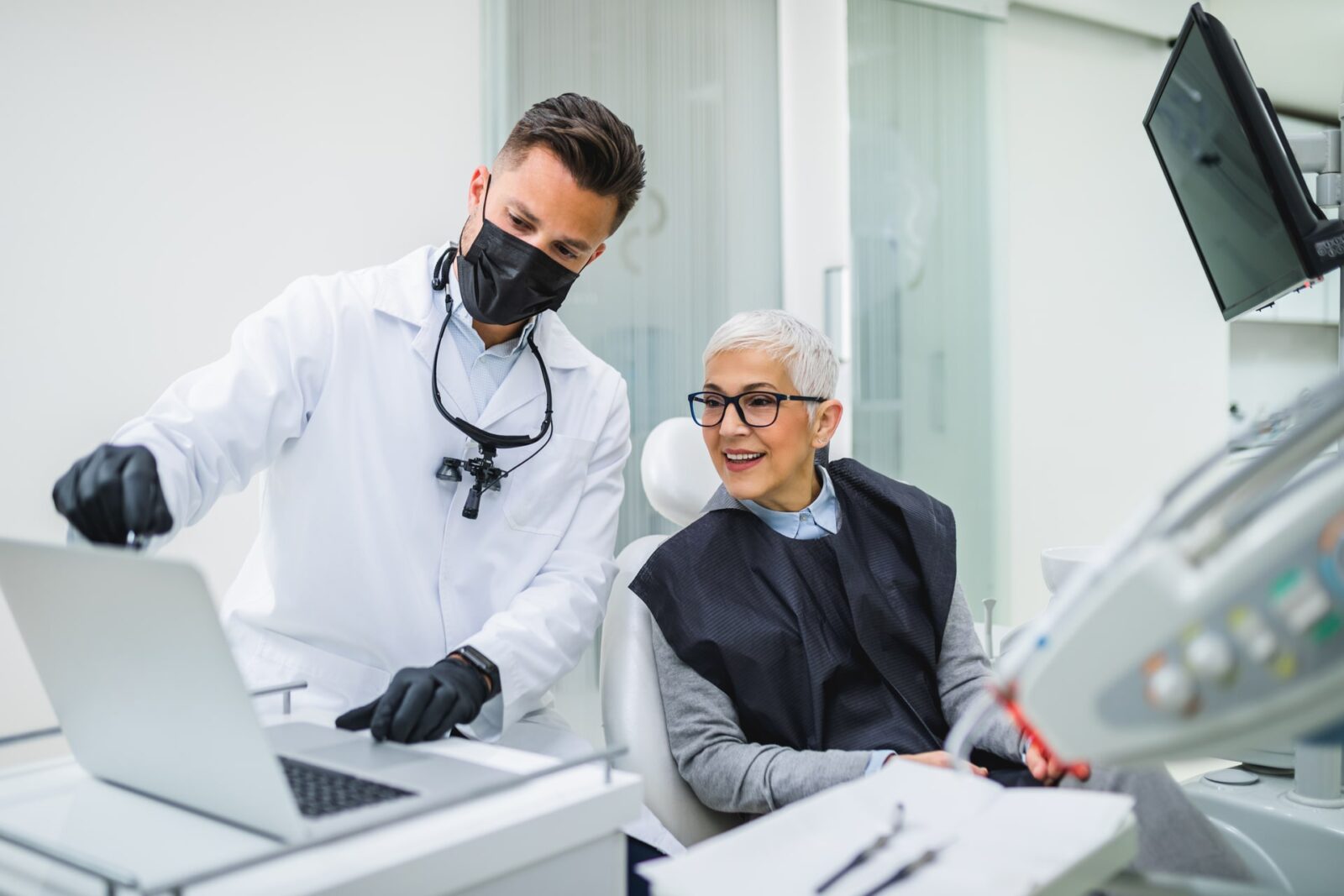 Beautiful senior woman having dental treatment at dentist's office