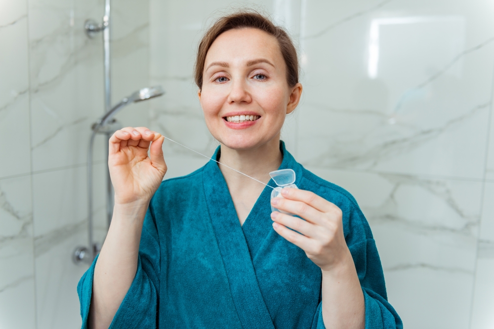 woman using dental floss