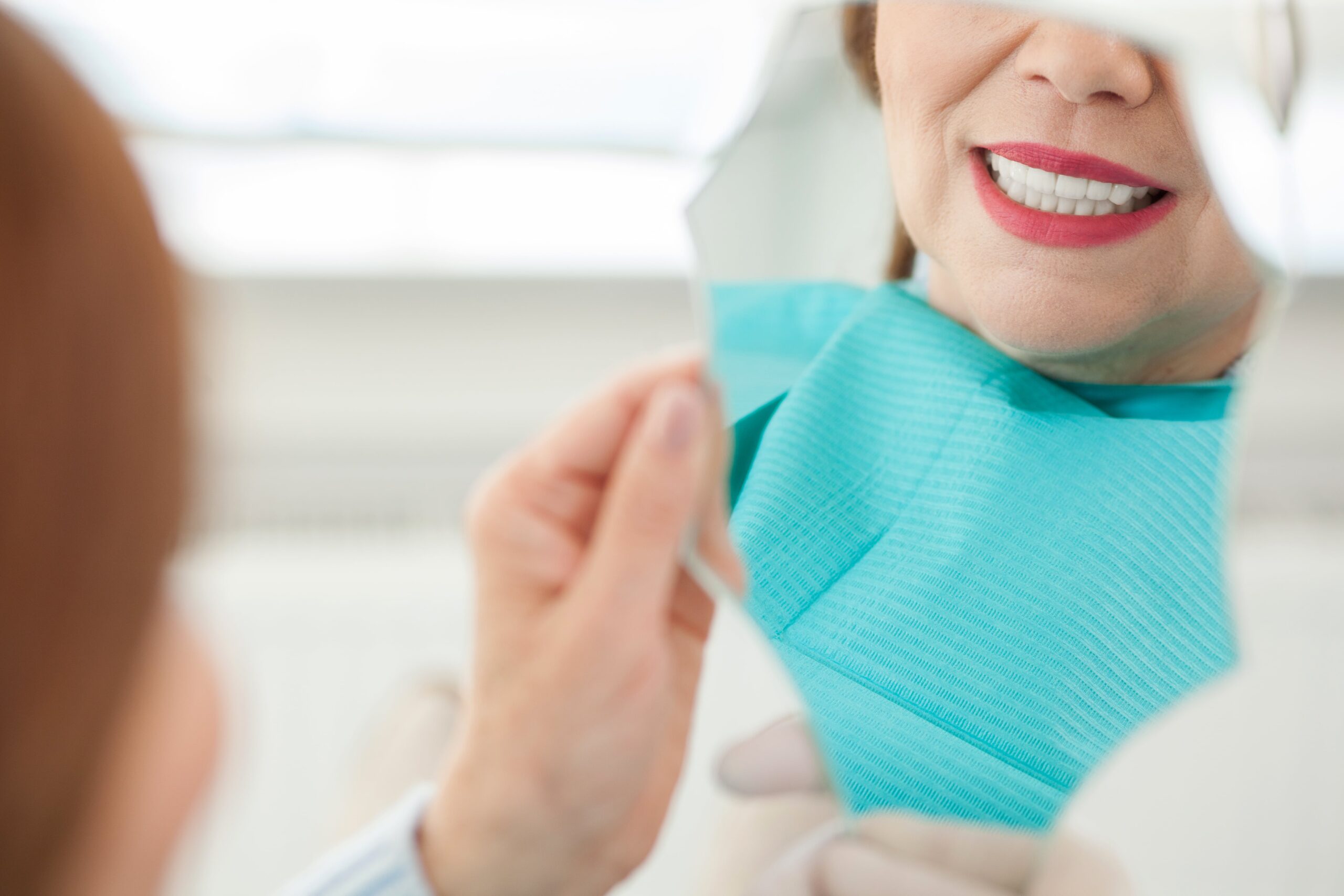 woman smiling in a mirror. closeup of smile