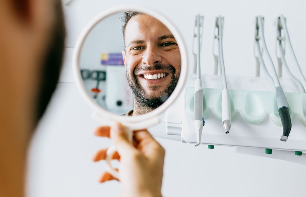 A man smiling after his Dental Cleaning and Consultation