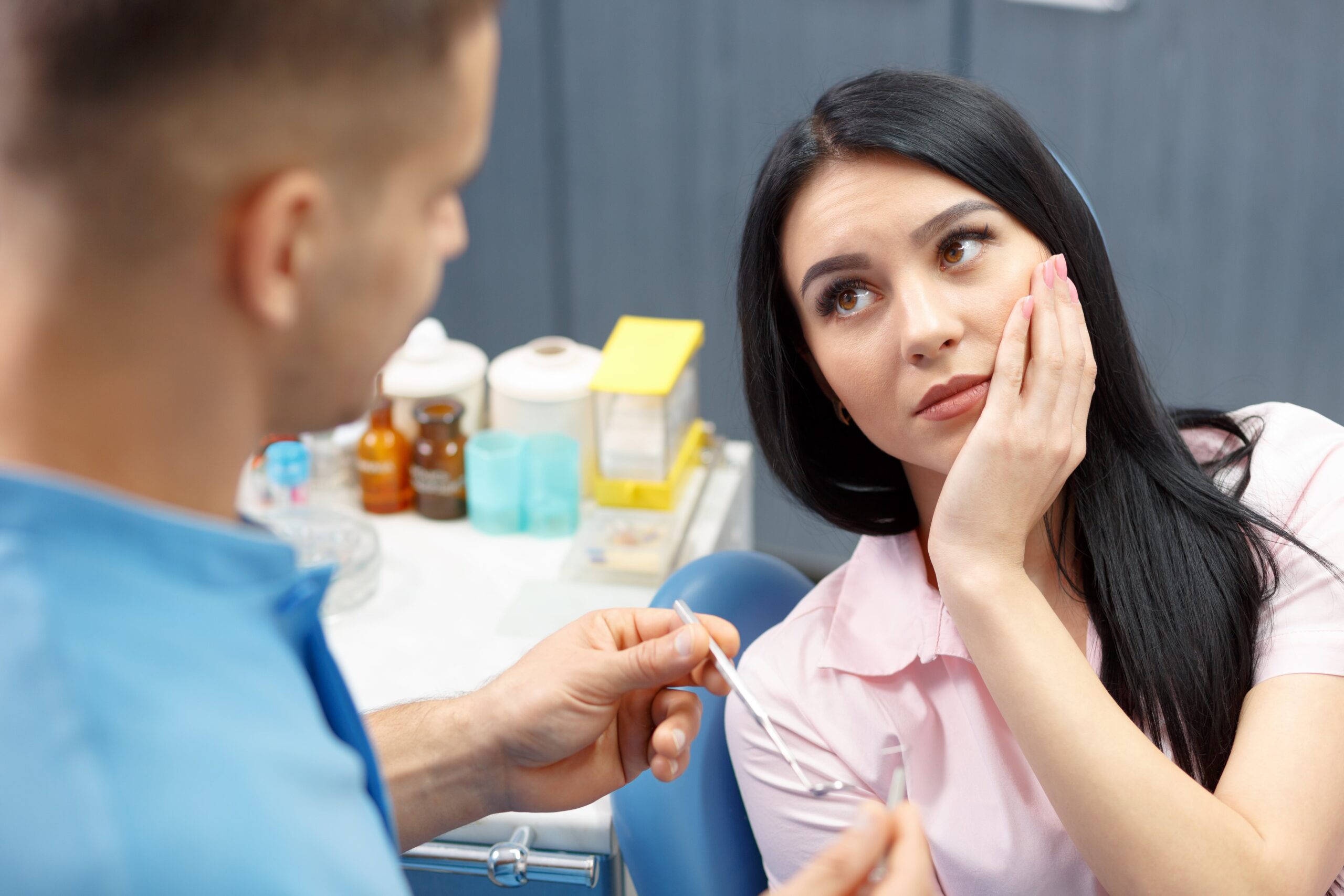 woman in dental chair with tooth pain