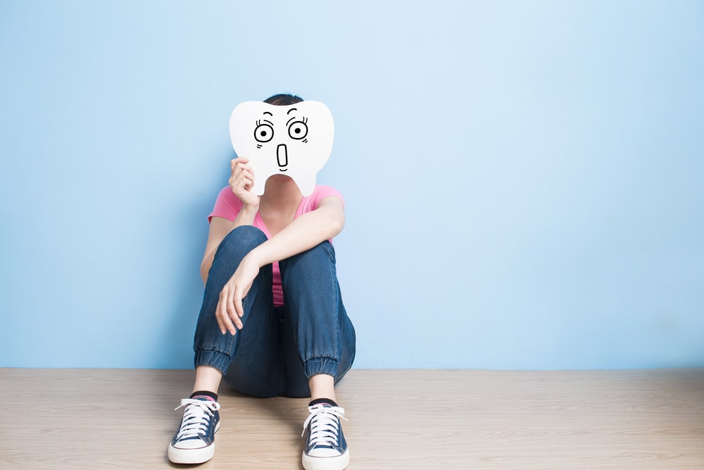 woman with giant stressed tooth in front of her face