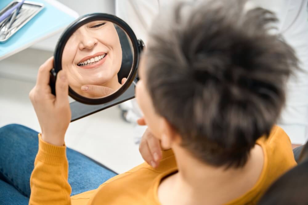 woman checking her dental implants