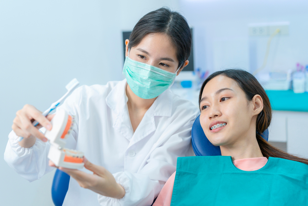 Asian,Young,Girl,Listen,To,Female,Dentist,Explaining,About,Oral