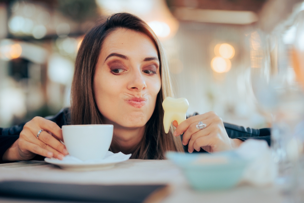 Woman Stressed About Teeth Coloring from Drinking Coffee.