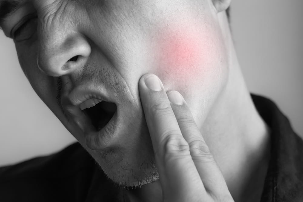 Closeup man suffering from toothache healthcare, dental care cavity problem ache pain sore jaw