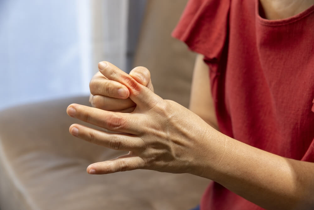 Senior Woman massage finger with painful swollen gout