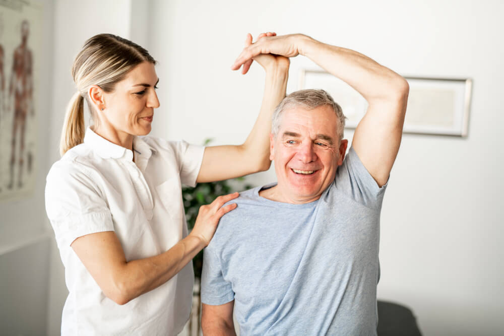 A Modern rehabilitation physiotherapy worker with senior client