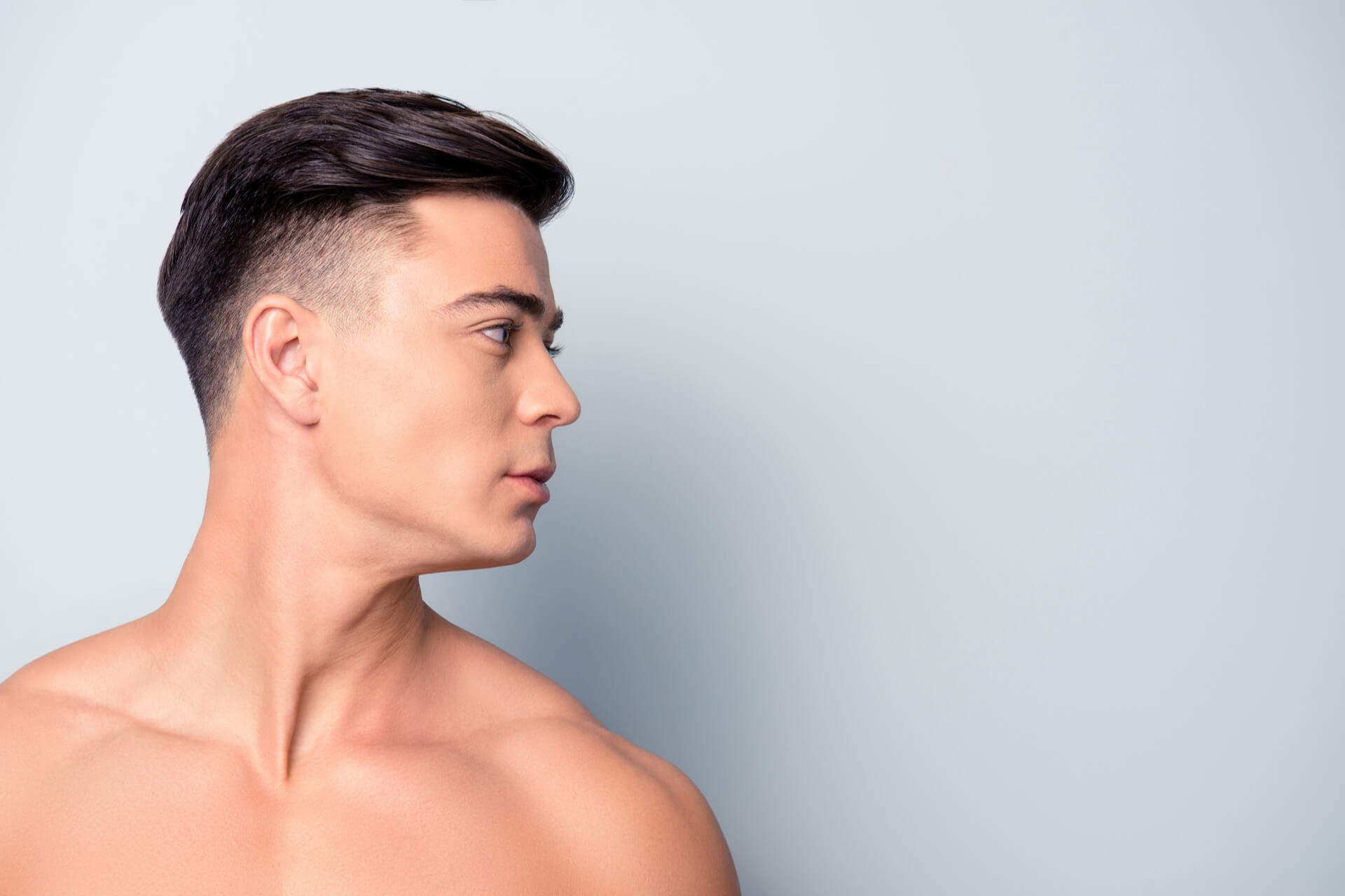 portrait of confident handsome shaven with flawless skin man