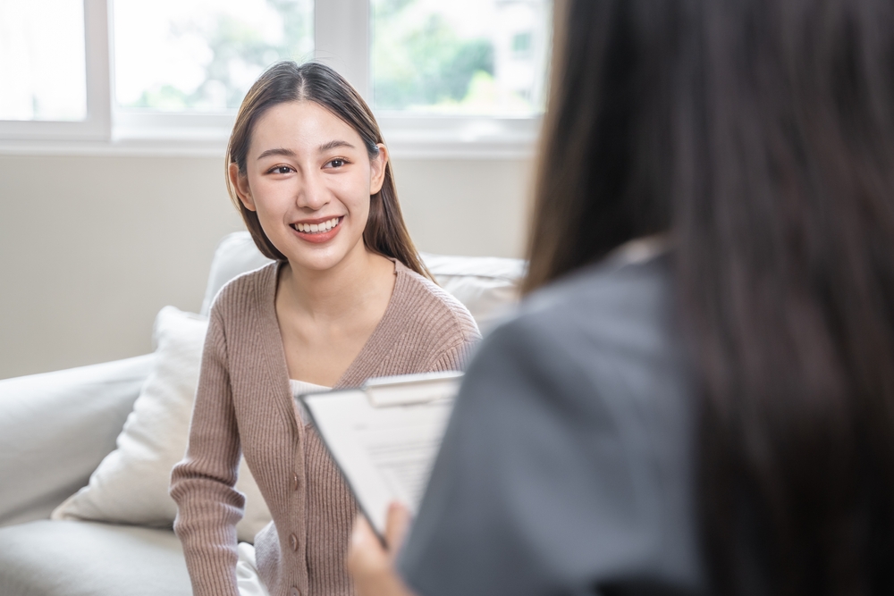 Young woman in a mental therapy session talking with a psychologist in the office.