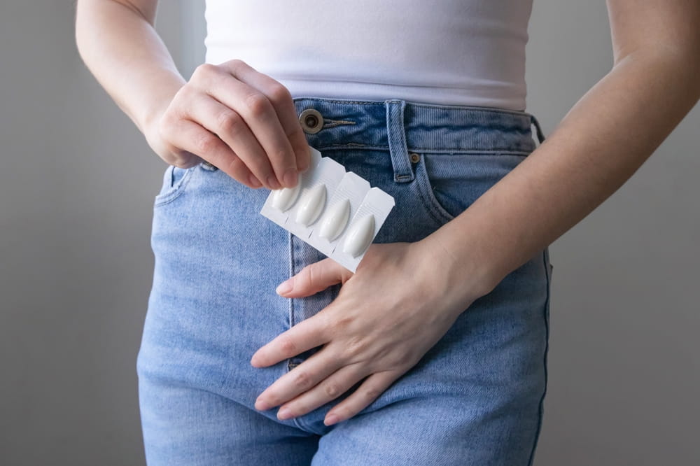woman holding vaginal suppositories, treatment for vaginal infections, thrush or bacterial vaginosis