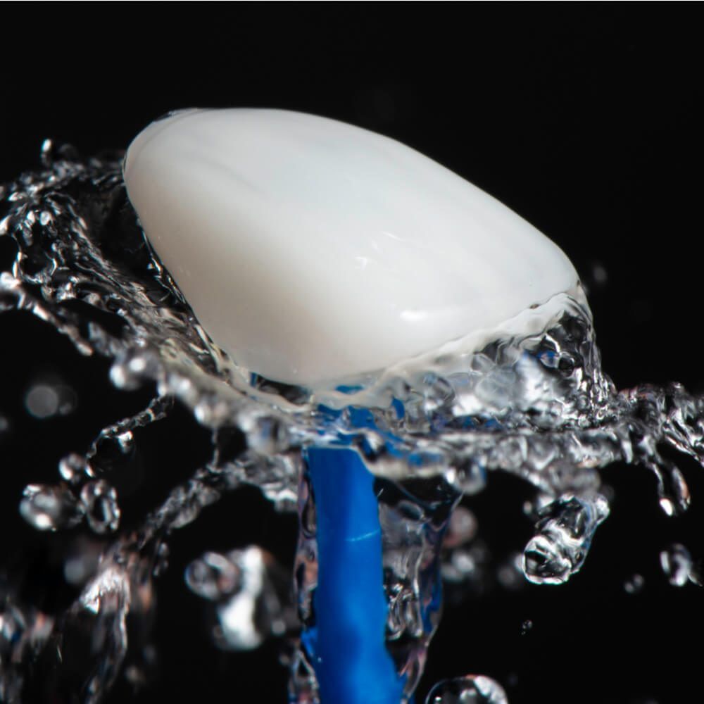 Artistic shot stop motion of water drop on dental ceramic veneers.
