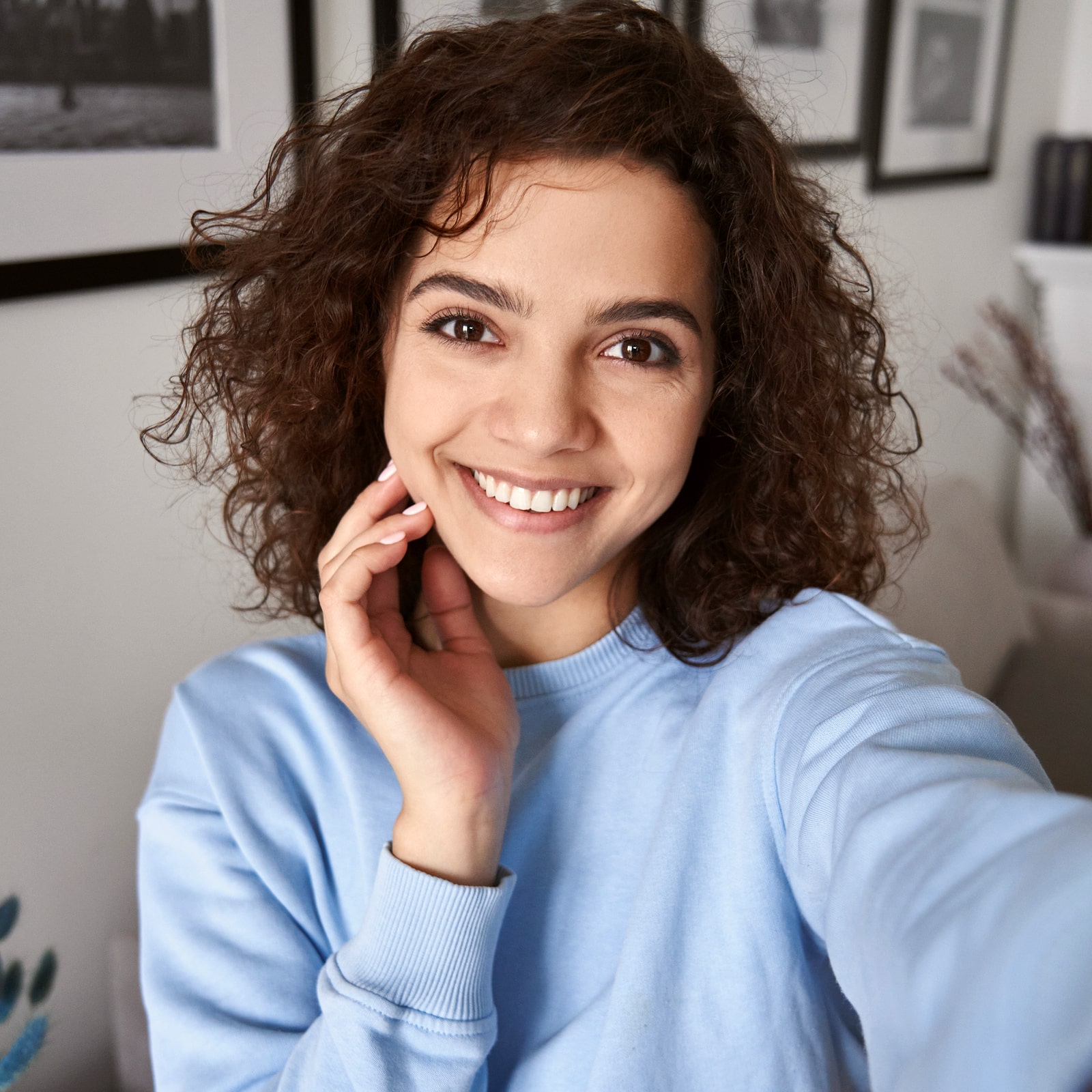 Happy pretty hispanic gen z teen girl holding smartphone