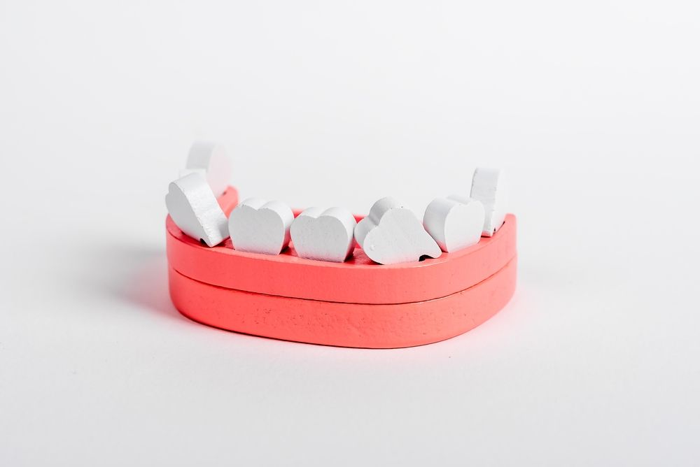 Wooden jaw model with loose crooked teeth