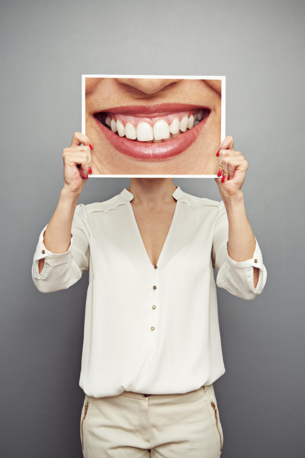 Girl holding smile banner on face