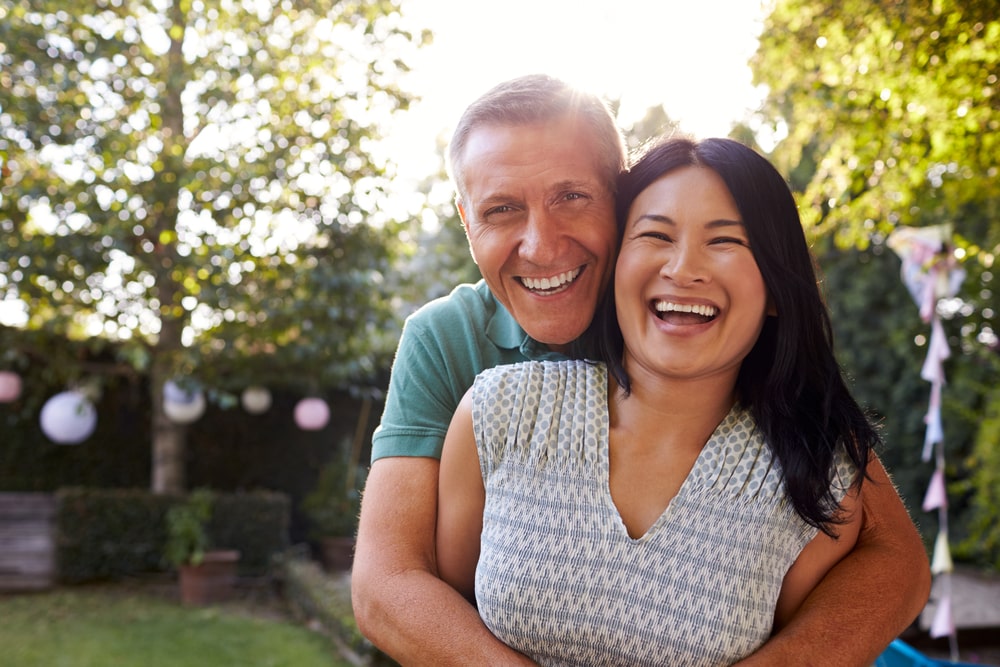 Loving Mature Couple In Back Yard Garden